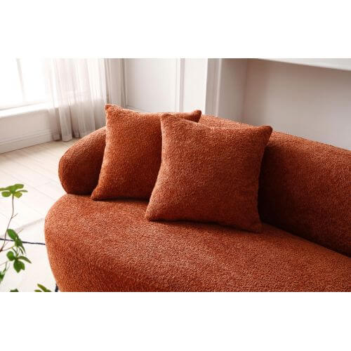 Curved boucle fabric sofa with plush cushions in modern living space