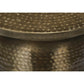 Close-up of distinctive hammered pattern on Hammered Metal Round Drum Accent End Table's bell-shaped base in brass color.