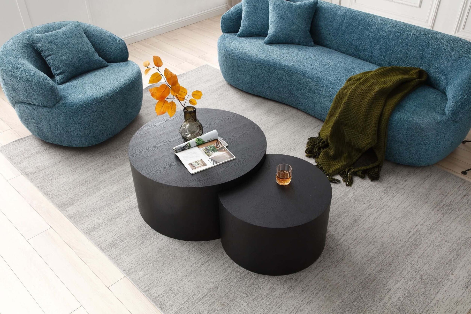 Modern curved boucle fabric 3 seat sofa in a living room setup with contemporary coffee tables