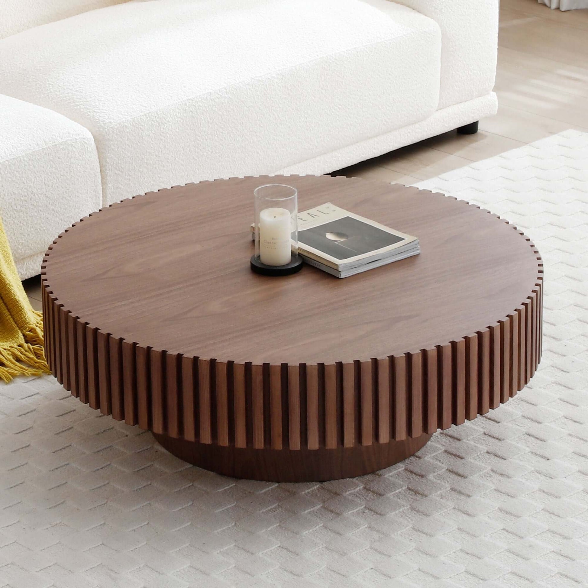 Modern round MDF wood coffee table with sturdy pedestal base in living room setting