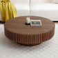 Round MDF wood coffee table with pedestal base in living room, decorated with candle and magazine