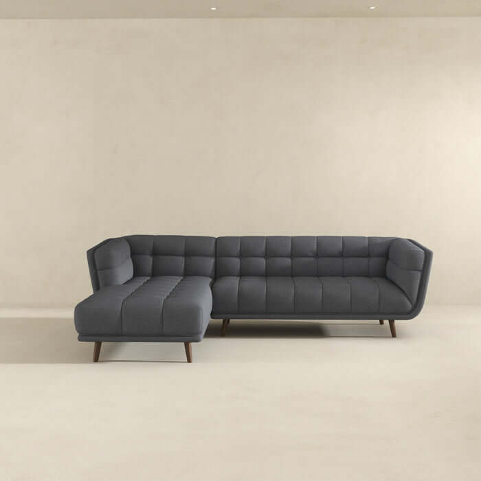 Addison L-Shape Tufted Grey Fabric Sectional Chaise Sofa with Solid Wood Walnut Legs against Cream Background