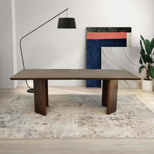 Alden 86" solid walnut wood rectangular dining table in modern dining room with art and plants.