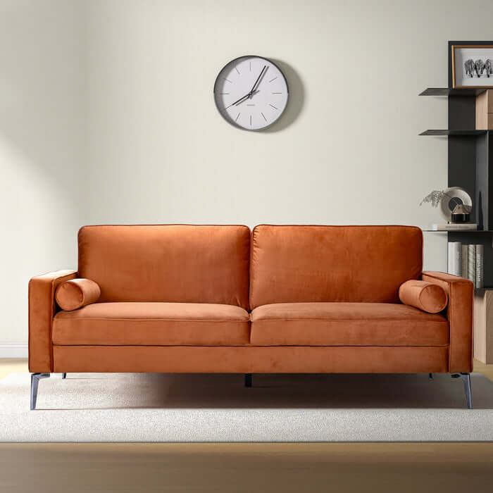 Axten MCM orange velvet sofa 77" with detachable boxed arms in a modern living room.