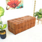 Luxurious Benjiro Button Tufted Rectangular Leather Ottoman in mid-century modern style in a chic, plant-filled living space