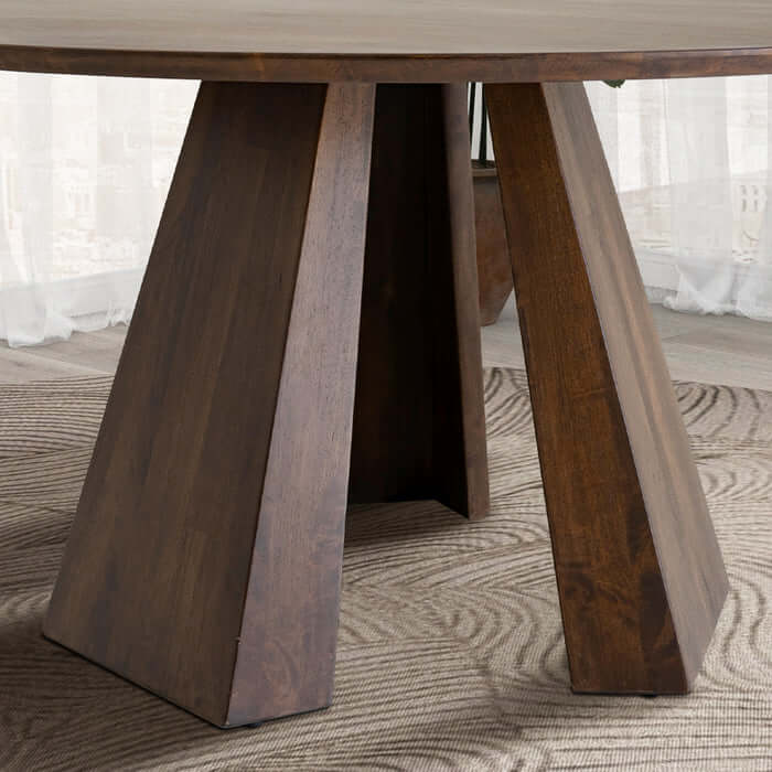 Pedestal base of Bolton Round Walnut Wood Dining Table 53" showcasing unique wood grain on rug background.