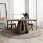 Bolton Round Walnut Wood Dining Table 53" with unique wood grain and pedestal base, set in a modern dining area with two chairs.