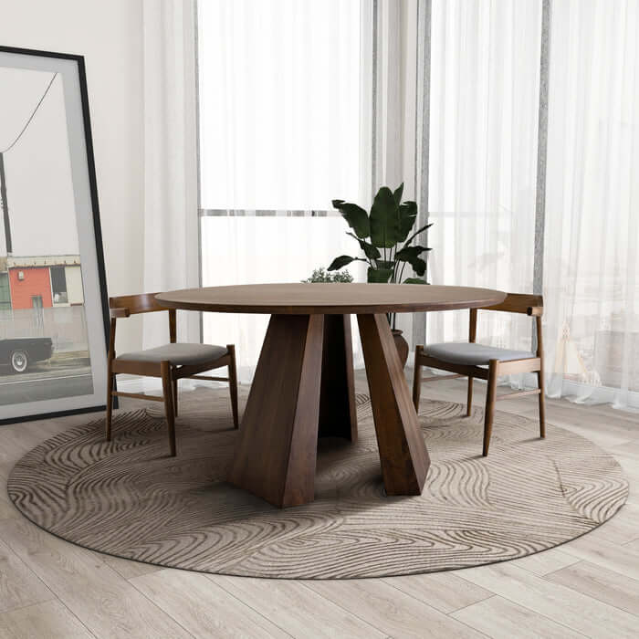 Bolton Round Walnut Wood Dining Table 53" with unique wood grain and pedestal base, set in a modern dining area with two chairs.