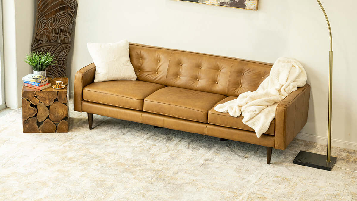 Braxton MCM Tan Genuine Leather Button Tufted Sofa (88") in a modern living room setting