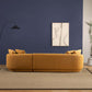 Chandler Boucle Right Facing Chaise Sectional Sofa in mustard yellow, sleek Japandi mid-century design, against a modern blue wall