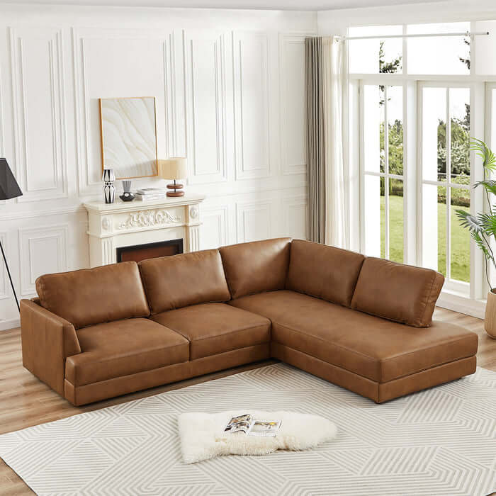 Glander Modern Leather Sectional Chaise Sofa in living room with large windows and fireplace