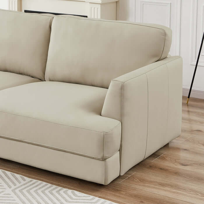 Glander Modern Leather Sectional Chaise Sofa 108" in beige displayed in a stylish living room with wooden floor and contemporary decor