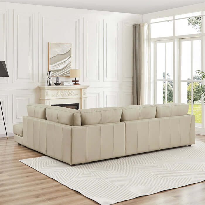 Glander modern leather sectional chaise sofa 108" in stylish living room with large window and fireplace