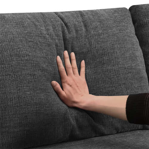 Hand pressing cushion of Modular U Shape Dual Chaise Chenille Fabric Sectional Sofa for plush comfort demonstration.