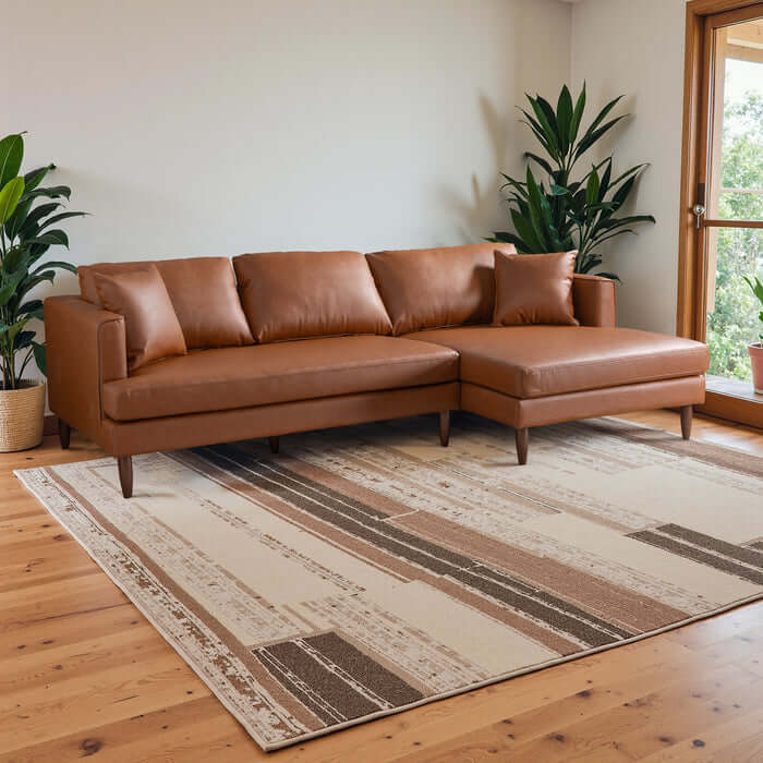 Blake L-Shaped cognac leather sectional sofa with chaise in a modern living room setting.