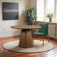 Palamedes Solid Wood Round Table in Walnut with green chair, indoor setting, Mid-Century Modern design.