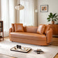 Dylan Modern Cognac Faux Leather Sofa 85" in a stylish living room setting with elegant decor and warm lighting.