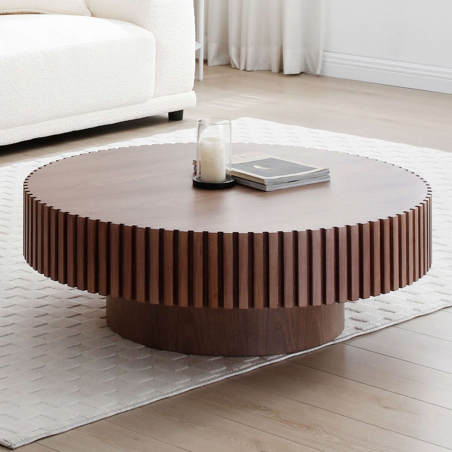 Round MDF wood coffee table with pedestal base in living room setting, perfect for apartments and small spaces