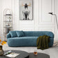 Modern Curved Boucle 3 Seat Sofa in Blue in a stylish living room with wall art, tall lamp, and cozy decor.